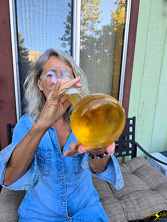 Lois sipping on a yard of beer