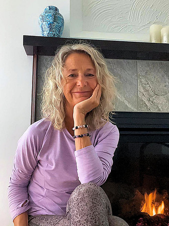 Lois posing at her fireplace